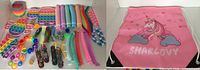 Overview of assorted colorful fidget toys including pop its, squishy peas, up to 45 individual toys, alongside the pink unicorn drawstring bag with clouds and name 'SHARLOVY' printed on it.