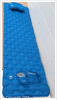 Full view of the blue sleeping pad showing the air cell pattern and attached pillow.