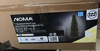 Box label showing NOMA 7 Boulevard Pencil Tree, 7 feet tall, 26 inch width, 200 LED lights, new.