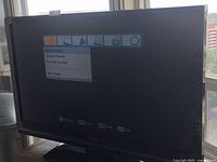 Front view of Toshiba TV powered on showing application menu screen titled 'Applications' with options like Channel Browser and Favorites Browser.