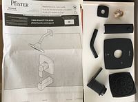 Contents of Pfister Deckard LG898DAB tub and shower trim kit laid out with installation guide showing key trim parts in matte black finish.