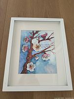 Framed original watercolor painting of cherry blossoms by Finnish artist Salla Paivaniemi, 8x10 inches artwork with white wooden frame.