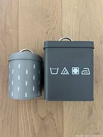 Top-down view of the two tins showing their size difference and designs