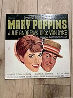 Front cover of Mary Poppins original cast sound track vinyl record showing illustrated portraits and track information.