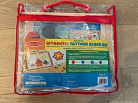 Clear packaging of Melissa & Doug Wooden Magnetic Pattern Block Kit showing product information and images of included blocks.