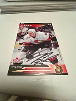 Front of the autographed Mike Fisher hockey card showing player in Ottawa Senators uniform with autograph.