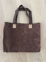 Reclaimed brown leather tote bag with beige accents and double straps shown from outside.
