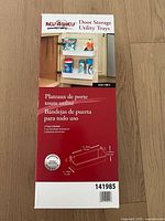 Photo of the front facing packaging of Rev-A-Shelf Door Storage Utility Trays, showing usage example and size dimensions.