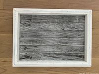 Top view of rustic wood tray showing white distressed frame and gray wood-patterned base.