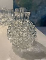 Photo of the vintage clear glass vase showing diamond cut pattern and rounded shape.