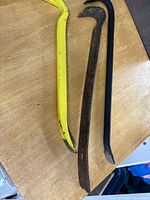 Three crowbars laid on table, showing colors and ends