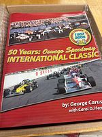 Front cover showing title, authors, and race car imagery