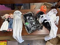 Group shot of six Halloween items laid on wooden surface