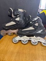 Side view of both skates showing boots, frames and wheels