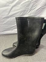 side view of both black rubber boots