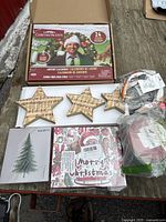 Lot overview showing advent calendar, wood stars, cards, ribbon, light set