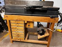 Full view jointer on cabinet stand, motor visible