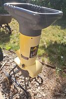 Full view of yellow McCulloch garden shredder on wheeled stand