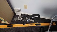 Plate joiner with dust bag, power cord, manual, spare blade and Bostitch level on floor
