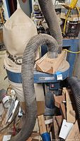 Reliant dust collector showing cloth bag, hoses, and adapter