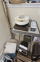 Projector on table with carousel tray and bulb box visible, accessories underneath