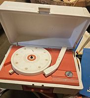 General Electric portable record player with lid open, showing turntable and tone arm