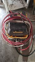 Top view showing Wagner logo, hose coiled on unit