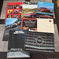 All eight brochures laid out on table