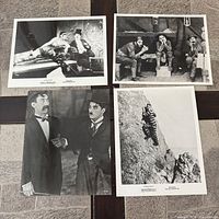 Group view of all four Charlie Chaplin photographs laid out on tiled surface