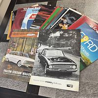 Stack of multiple Ford brochures fanned out