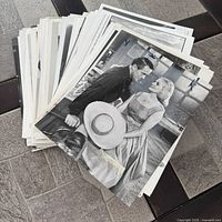 Front view of stacked publicity photos showing top black-and-white film scene print