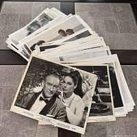 Stack of large quantity of vintage photographs on table