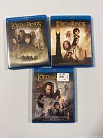 Front view of three Blu-ray cases showing cover art