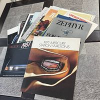 Stack of assorted Mercury brochures, top showing 1971 Mercury Station Wagons booklet