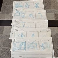 Stack of five storyboard sheets showing front sheet and edges of others