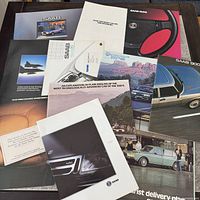 Group shot of all SAAB brochures spread on table