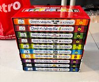 Stack of 10 Diary of a Wimpy Kid hardcovers in slipcase showing spines and title list
