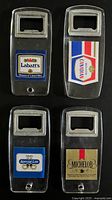 Four clear acrylic bottle openers with different beer logos displayed together