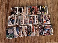 Spread of Roberto Alomar baseball cards laid out on wood surface