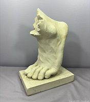 Front angled view of resin foot sculpture bookend