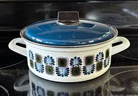 Side view of pot showing pattern, handles and lid