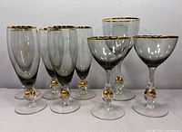 Front view of all eight Josef Stanik crystal glasses