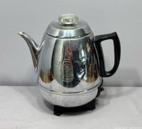 Full view of chrome General Electric percolator, handle, spout, glass knob lid visible