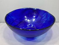 Oblique view showing cobalt blue color, internal swirls, rim shape