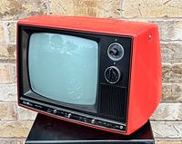 Front angled view showing red cabinet, screen, knobs, antenna mount