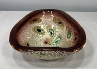 Front angled view showing overall form, rim color, millefiori decoration