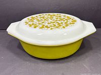 casserole with lid, side view showing pattern lid and olive base