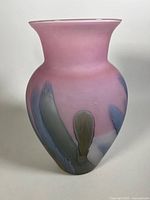 Front view of glass vase showing hand painted design in blue and brown on pink background with satin finish.