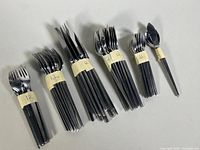 Photo showing all the groups of flatware pieces neatly arranged and banded, illustrating quantity and style.