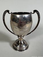 Front view of the sterling silver golf challenge trophy cup showing the engraved inscription